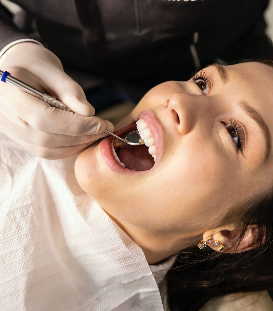 Dr. Shalini Thasma performing an orthodontic evaluation at Coit Dental in Frisco, TX