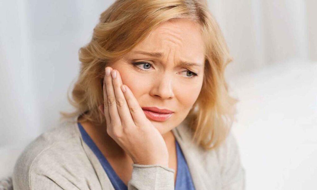 Emergency dentist caring for a patient with a severe toothache at Coit Dental in Frisco, TX